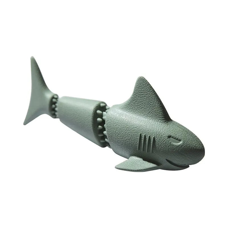Blue rubber shark-shaped dog toy with a hidden food compartment for interactive chewing and feeding.