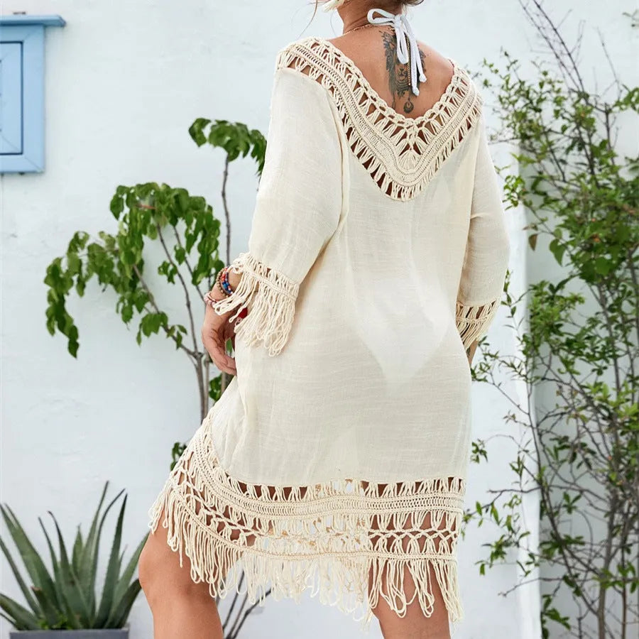 Apricot-coloured women's crocheted patchwork beach dress with half sleeves on a hanger.