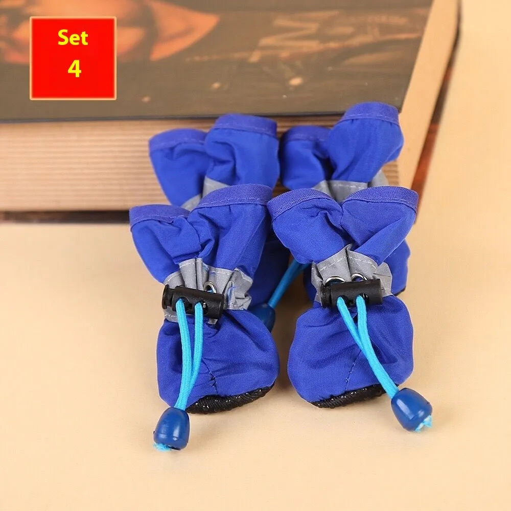 Set of four soft-soled cloth dog shoes for pets in assorted colours including red, blue, and black.