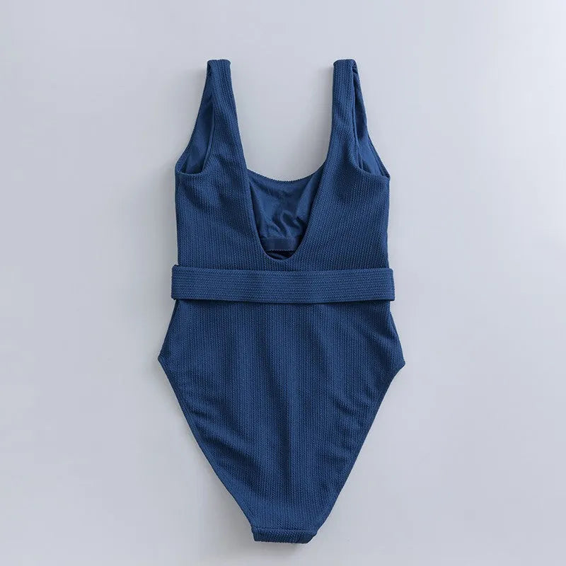Navy blue women's one-piece triangle swimsuit with chest pads on a mannequin, showing the sleeveless slimming design.