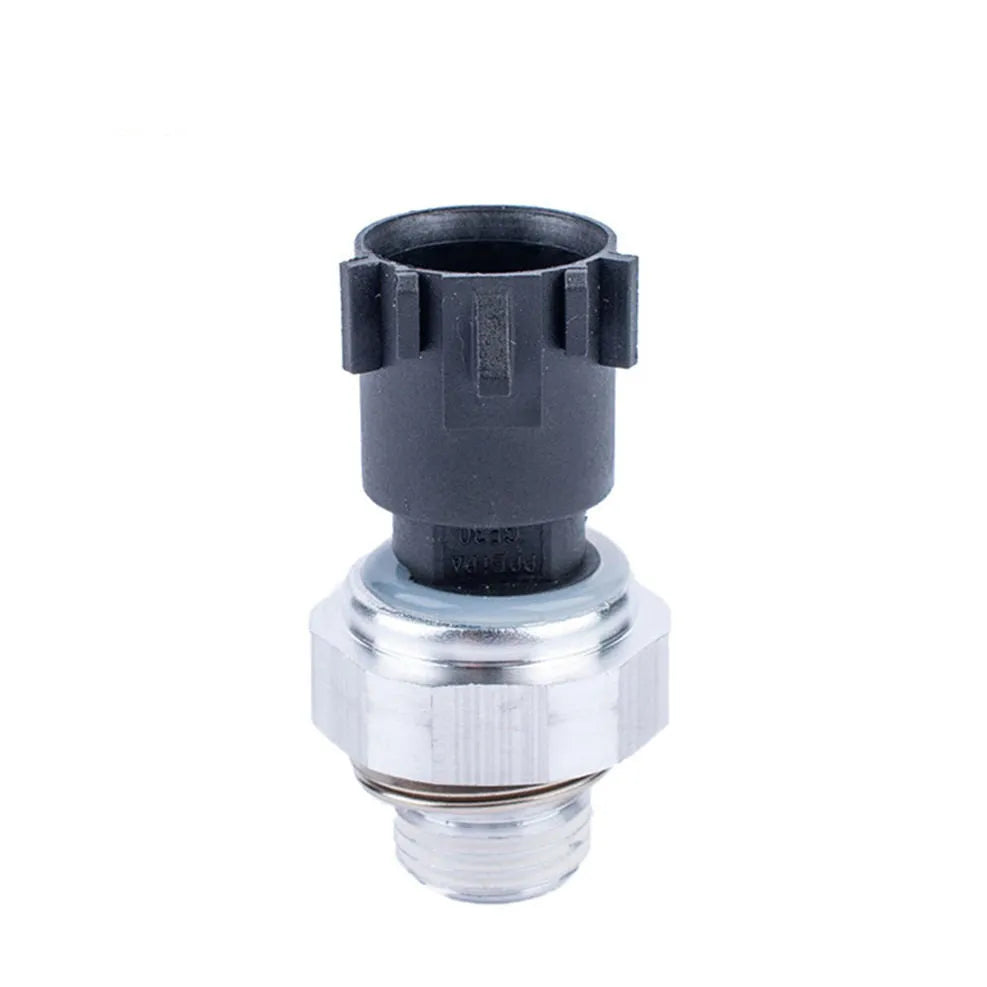 Silver automobile fuel pressure sensor replacement part on white background.