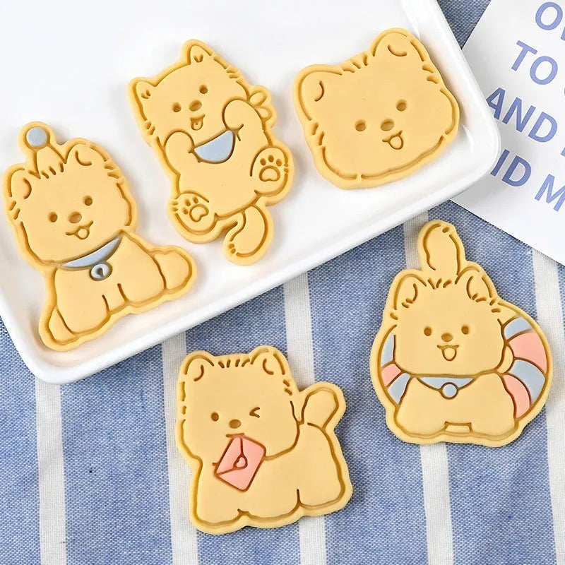 Plastic press mould for making puppy-shaped biscuits and soft candies with cartoon designs.