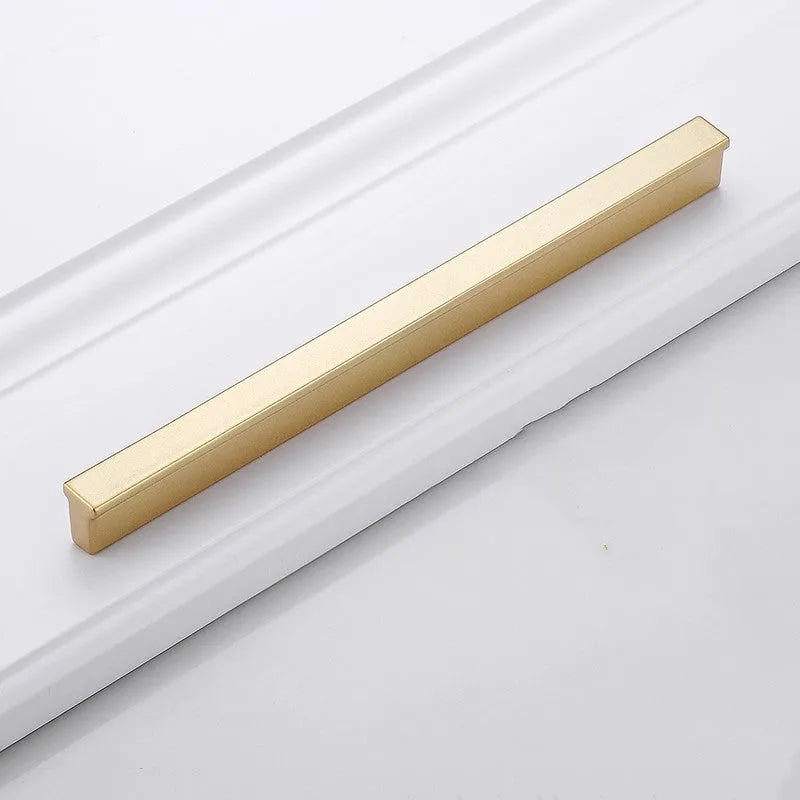 Gold coloured T-shaped aluminium alloy single hole cabinet door handle on a white background.