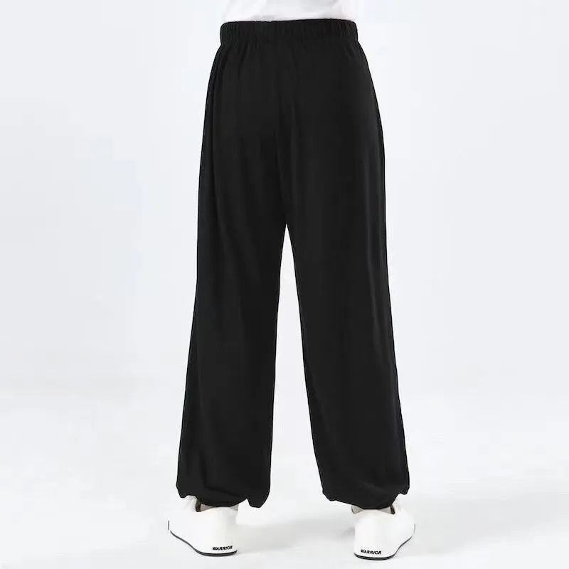 Black children's high-elasticity Sanda practice pants made from Lycra fabric, laid flat.