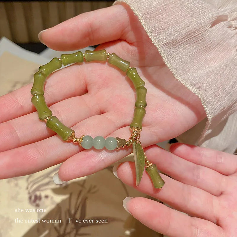 Chinese style glass bracelet with bamboo joint elements in red Lvzhu Duobao design