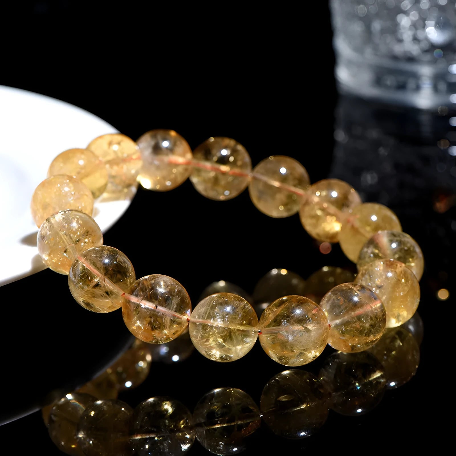 Natural yellow citrine gemstone bracelet with geometric beads on a white background.