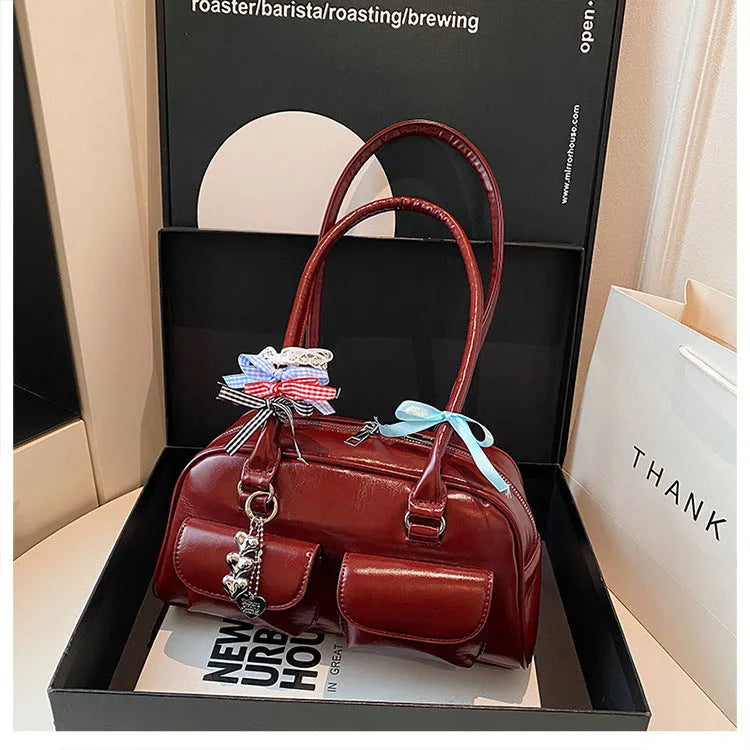 Retro brown PU leather pillow-shaped women's shoulder bag with double straps and a flap closure.
