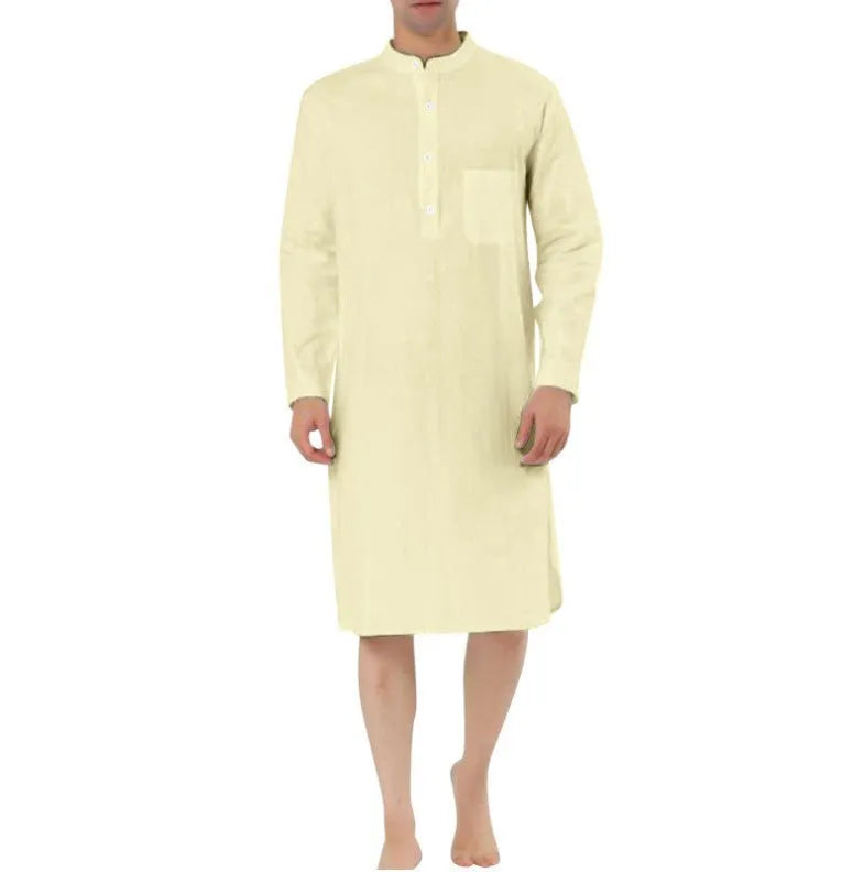A man's simple cotton shirt robe in a light colour, shown hanging, with visible button front and pockets.