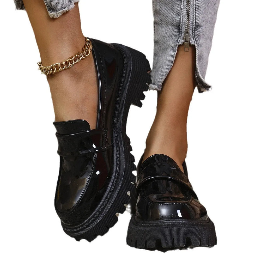 Black chunky heel loafers with a thick rubber sole and platform, shown from the side.