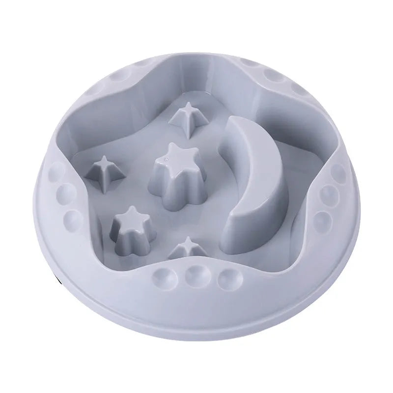 Large blue slow feed dog bowl with raised star and moon wing design on a wooden floor.