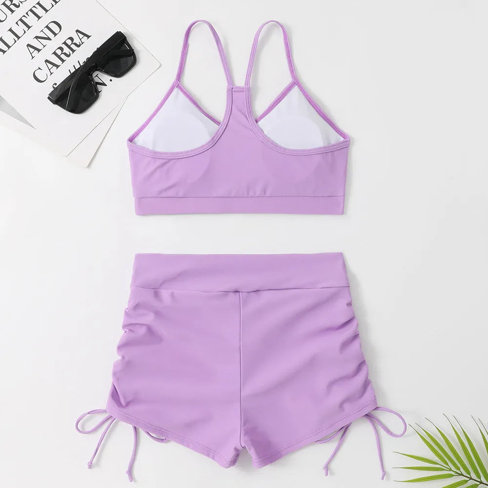 Women's black and violet high waist split bikini swimsuit for surfing and swimming.