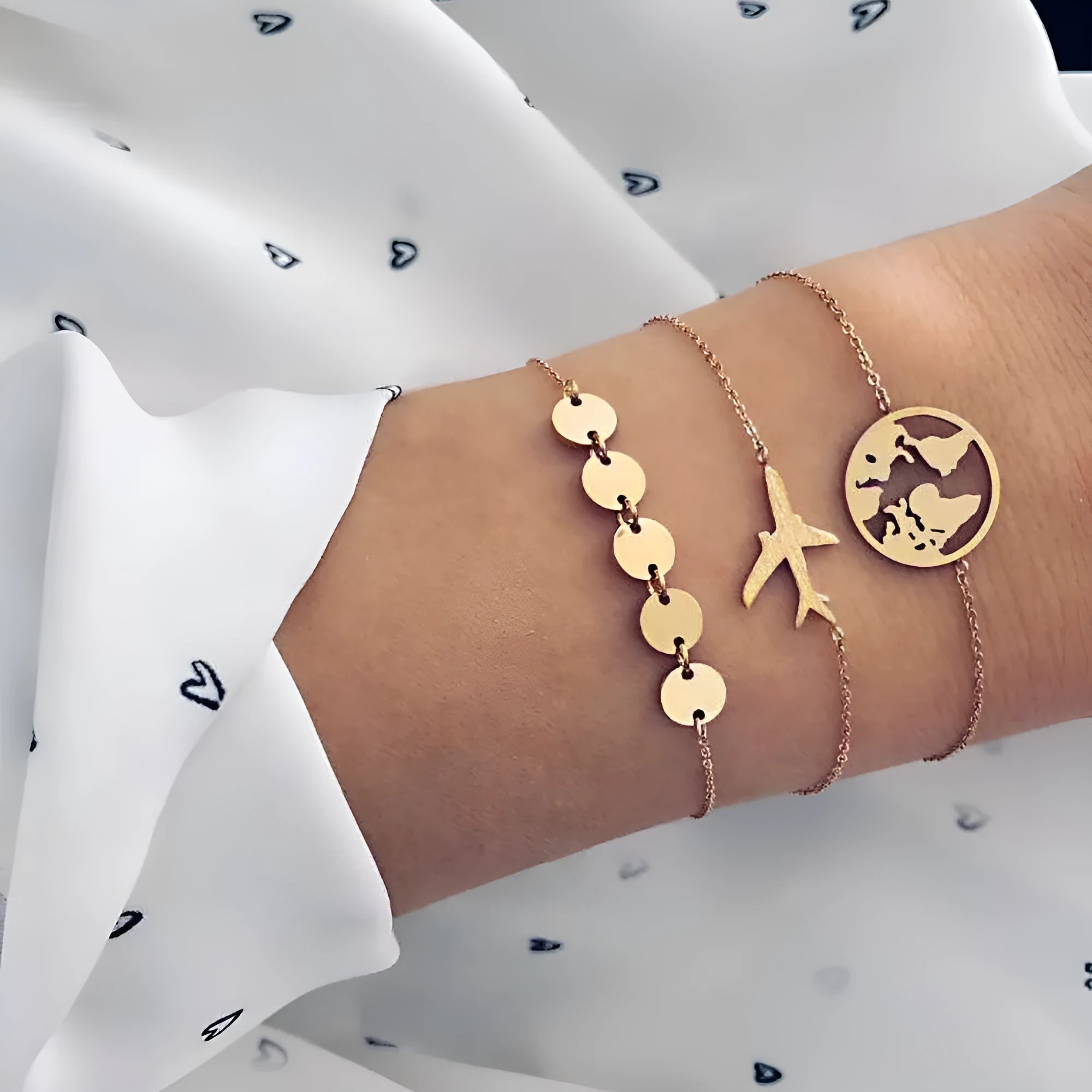 Three bohemian-style bracelets with aircraft map heart charms in electroplated alloy