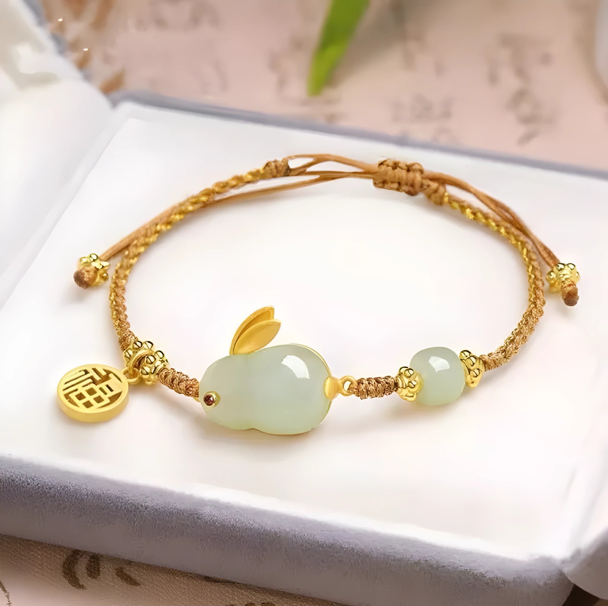 Hetian jade geometric rabbit charm bracelet on a yellow string for women.