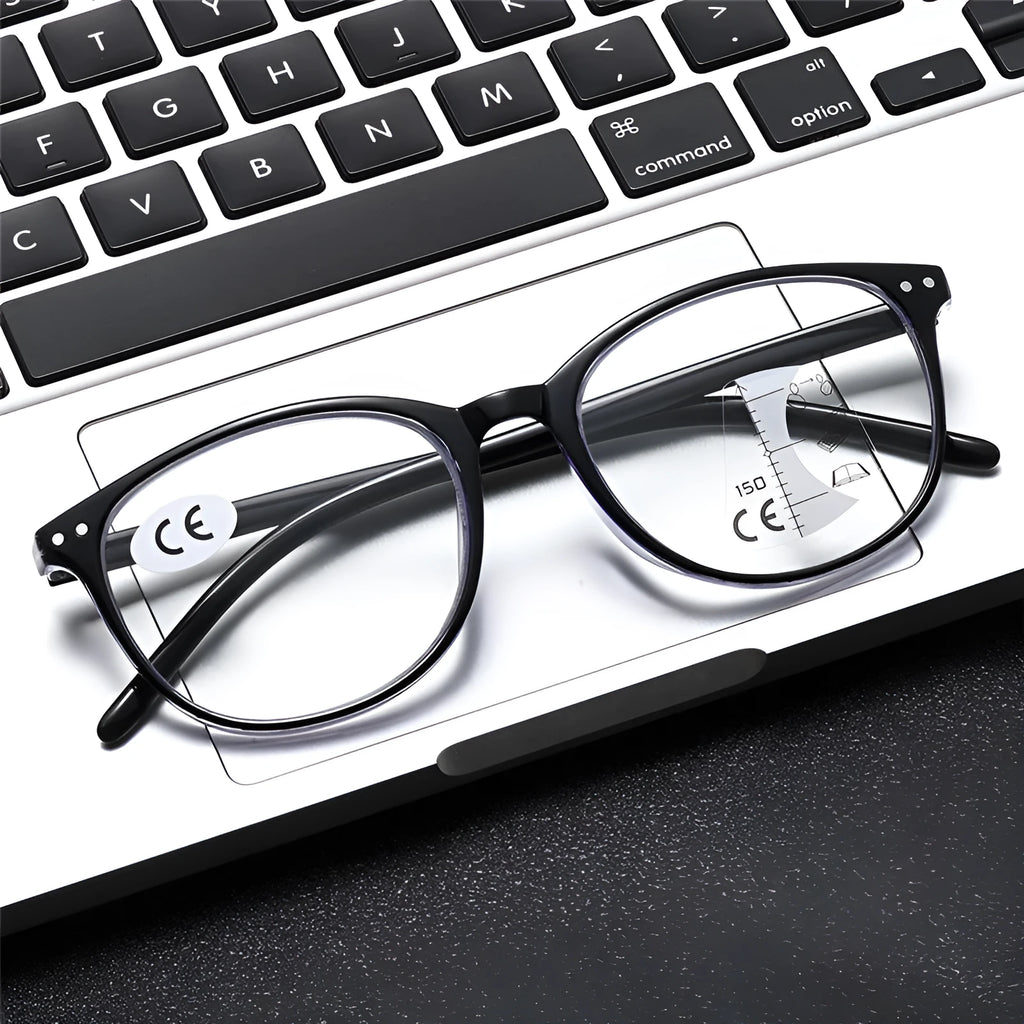A pair of women's ultra-light presbyopic glasses with metal frames and multi-focus lenses on a table.