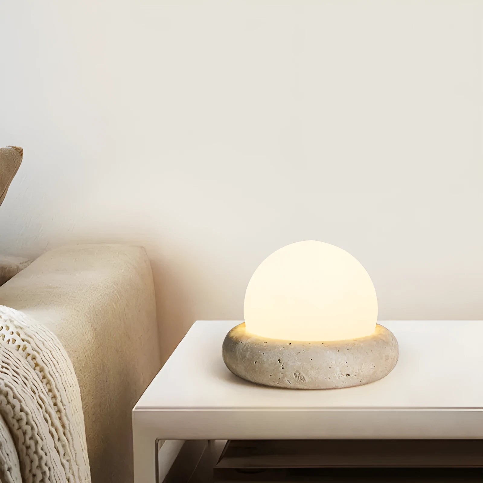 Cream style bedside night light with remote control on bedroom surface