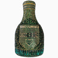 Gold champagne bottle shaped evening clutch with rhinestone decoration on black background