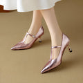Women's gunmetal leather pointed-toe pumps with a low-cut front and chunky mid-height heel.