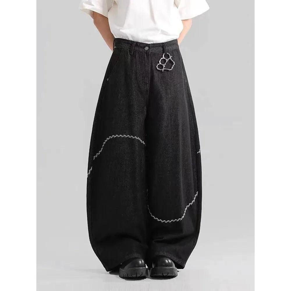Black straight-leg jeans trousers with mid waist and zip placket closure on teenage model