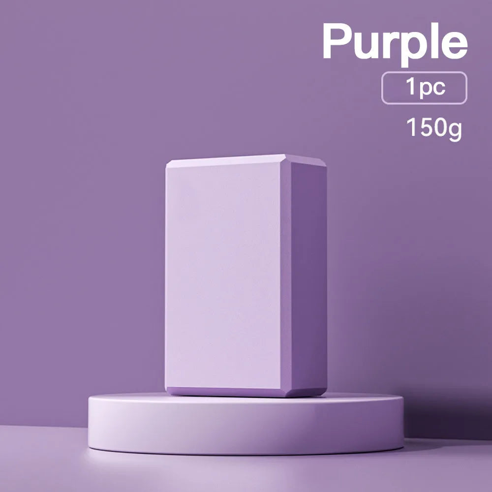 Solid colour EVA foam yoga block with hexagonal ridges, shown next to tape measure showing 23cm length