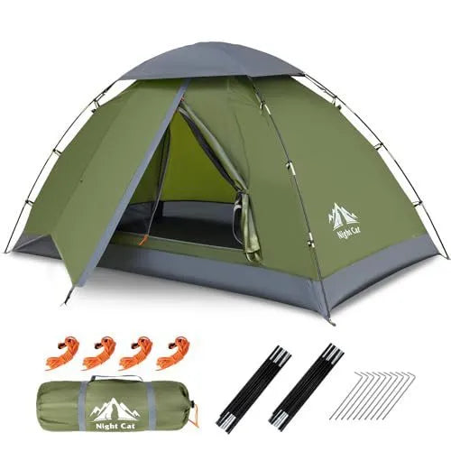 Dark green instant pop-up camping tent pitched outdoors, showing its automatic frame structure and two-person size.