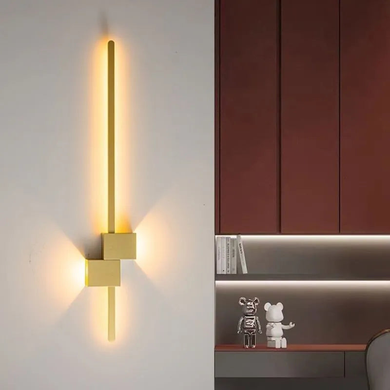 Modern minimalist wall lamp black 80cm length installed above a bedside table with warm low-voltage light