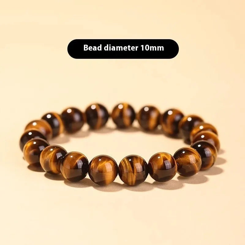 Single tigereye bead ethnic Buddha bracelet on wrist, showing simple rosary style.