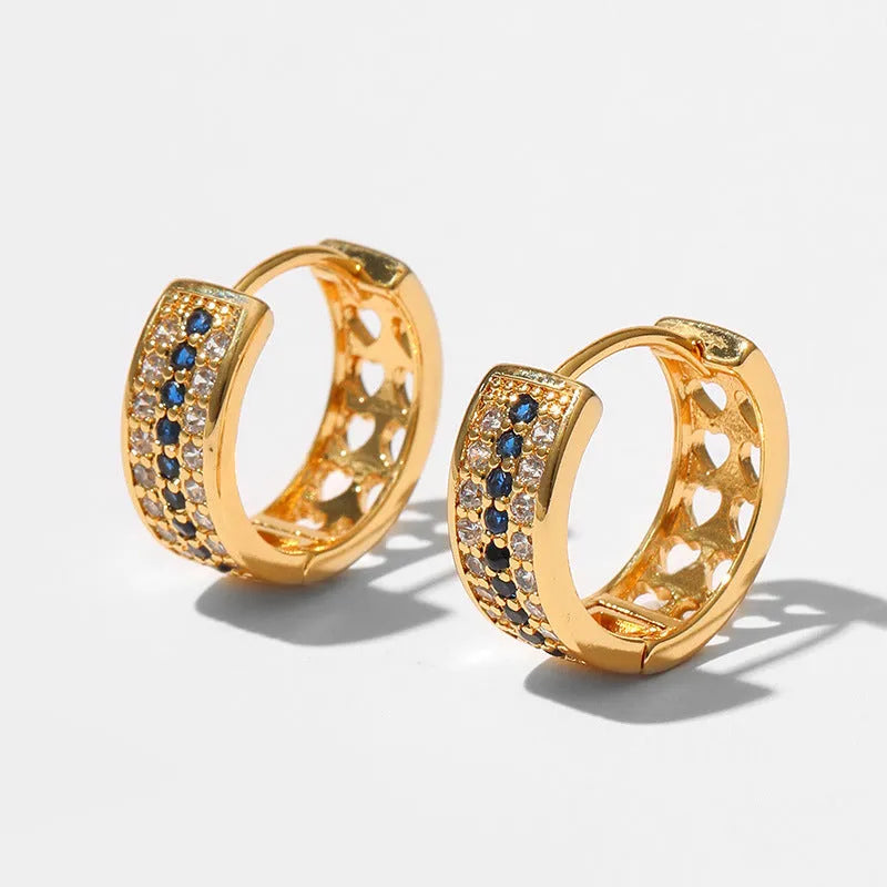 A pair of round, geometric copper earrings with an 18K electroplated gold-colour finish.
