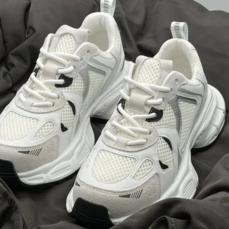 Beige mesh platform sports shoes with a wedge heel and lace-up front.