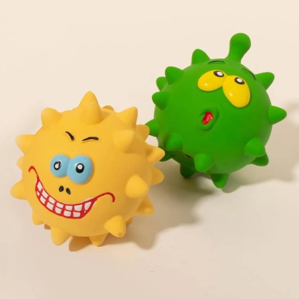 Set of four colourful squeaky dog balls with cute animal faces on a white background.