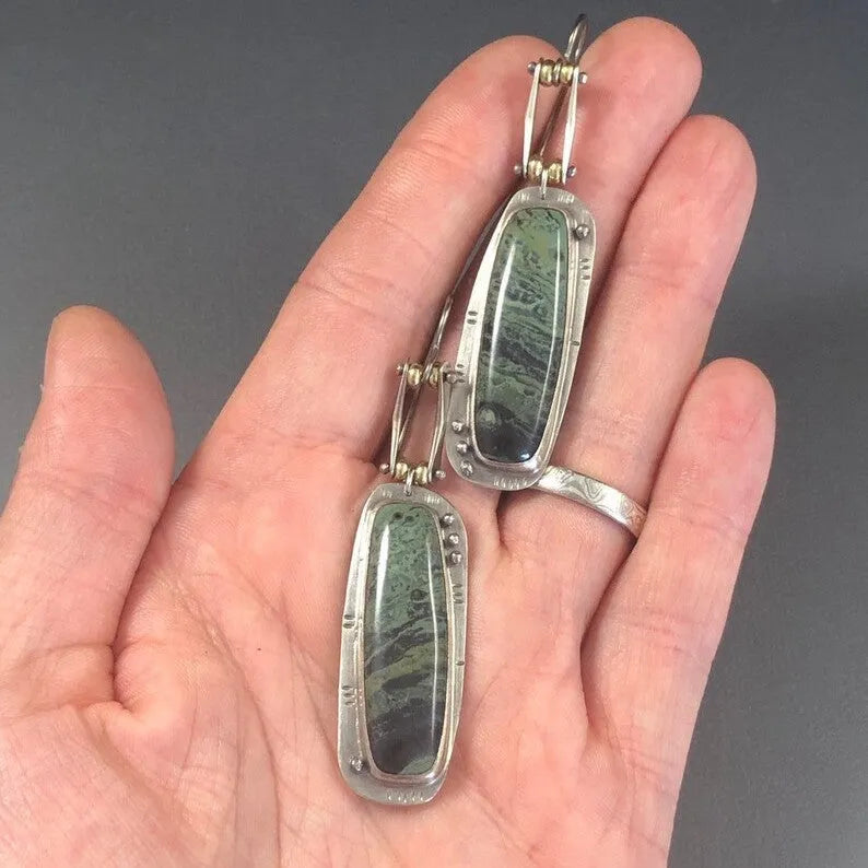 A pair of geometric-shaped fashion earrings with a two-colour marble pattern, made from alloy metal.