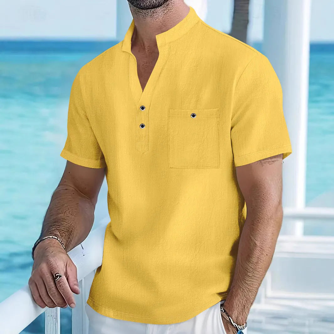 Man wearing a light-coloured linen stand collar short sleeve shirt in a loose fit.