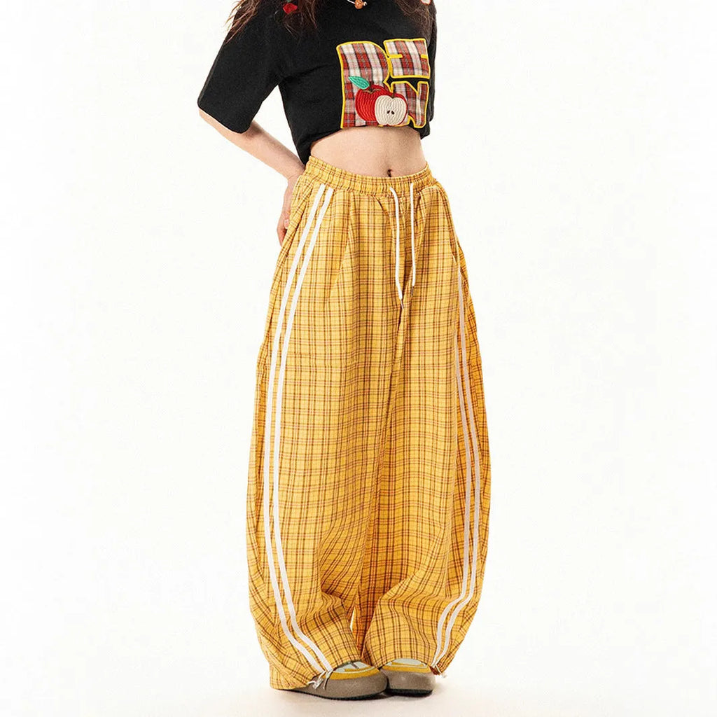 Blue loose straight wide leg polyester trousers with pockets and mid-waist design on a model