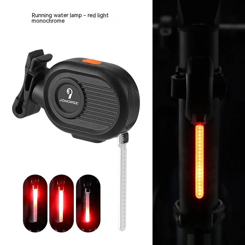 Blue LED waterfall effect bicycle rear safety light with USB Type-C charging port on a black background.