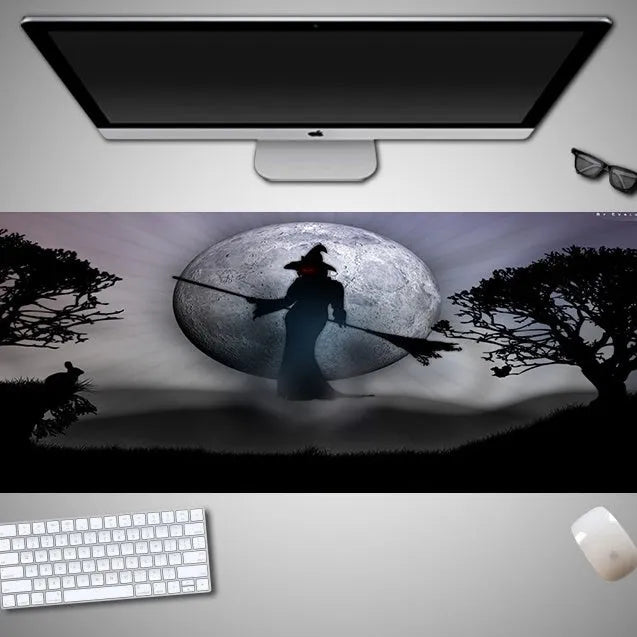 Oversized Halloween-themed gaming mouse pad on a desk, showing anti-slip base and graphic design.