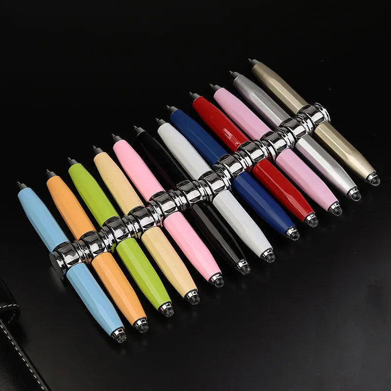 Metal gyro spinner ballpoint pen showing writing tip and spinning mechanism with LED lights