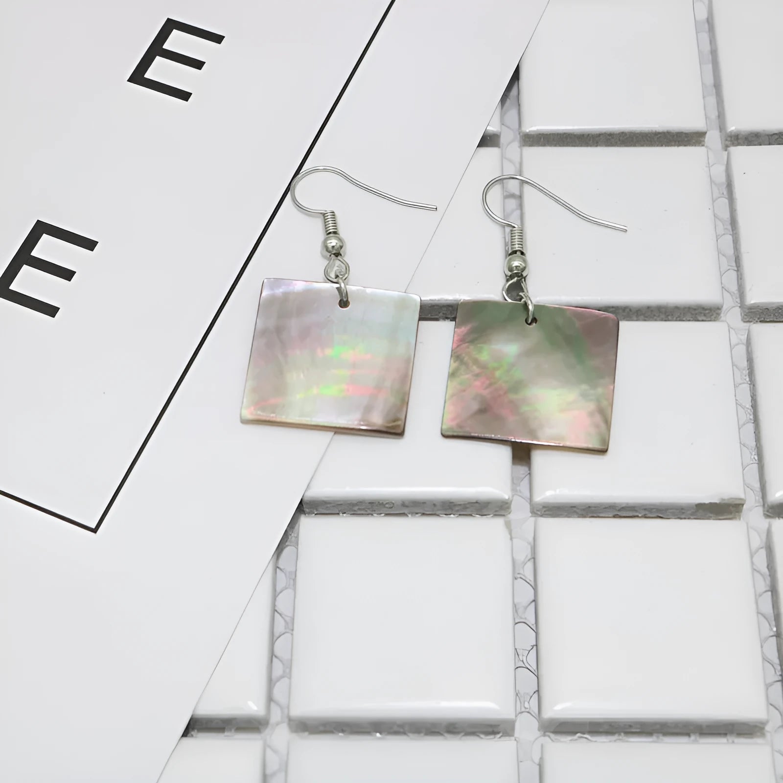 Women's geometric shell earrings in square panther or rectangular shell designs with natural material