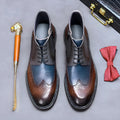 Men's coffee blue leather brogue boots with colour blocking and front lacing on a rubber sole.
