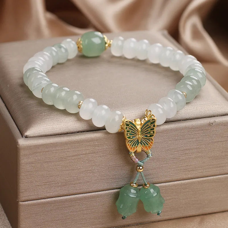 Green crystal women's bracelet with abacus beads and butterfly tassel decoration