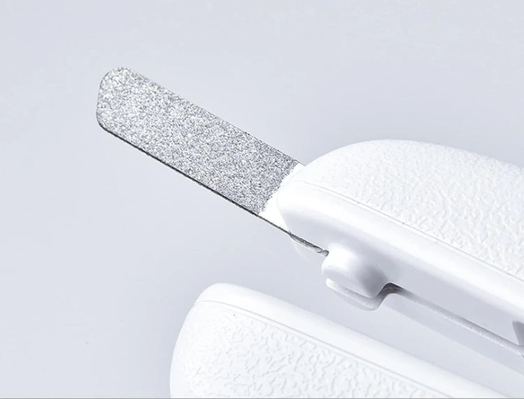 White pet nail clippers with LED light, transparent guard, triangular blades, and anti-slip handles for cat and dog grooming
