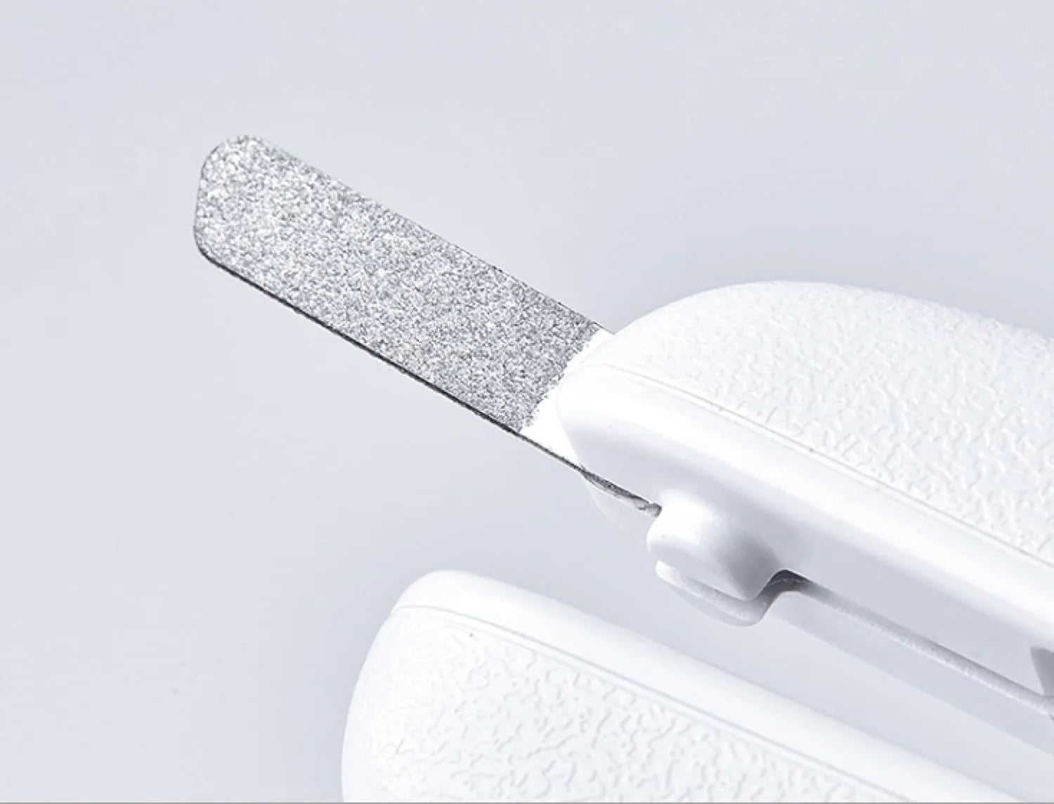 White pet nail clippers with LED light, transparent guard, triangular blades, and anti-slip handles for cat and dog grooming