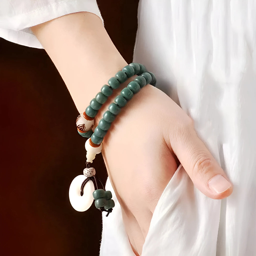 White jade bodhi seed bracelet with a double ring lotus safety buckle.