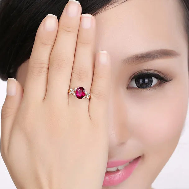 Women's rose gold plated butterfly ring with heart charm in red or blue colour options