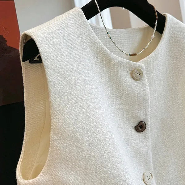 Women's milky white sleeveless bandage vest with round neck, laid flat on a surface.