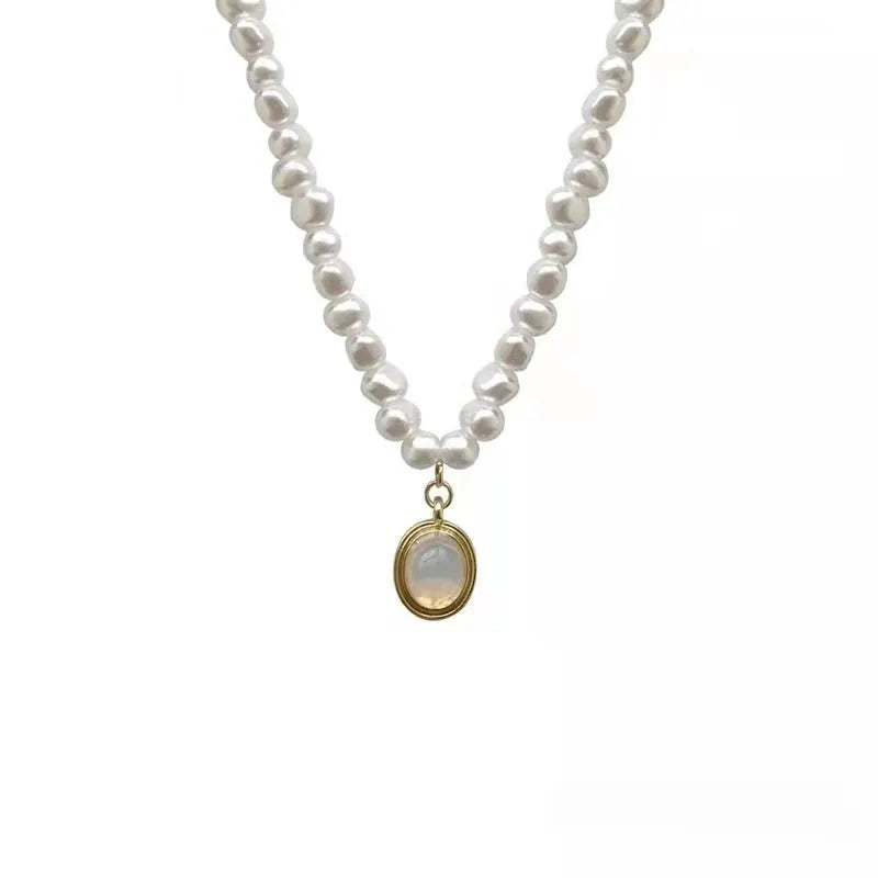 Adjustable French vintage style pearl necklace with geometric links on a white background.
