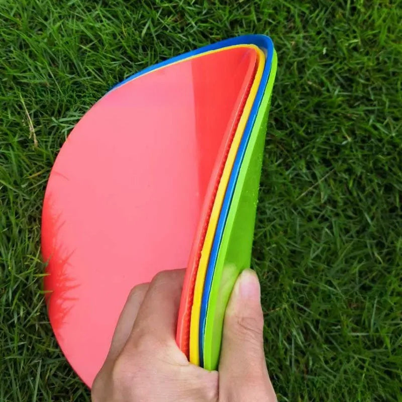 Soft coloured football training marker disc on grass field for target practice