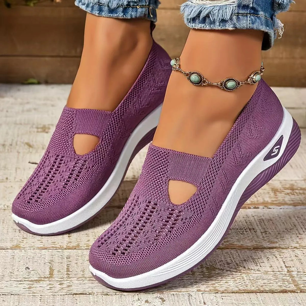 Women's low-top mesh casual flats with a T-strap in various colours on a soft PVC sole.