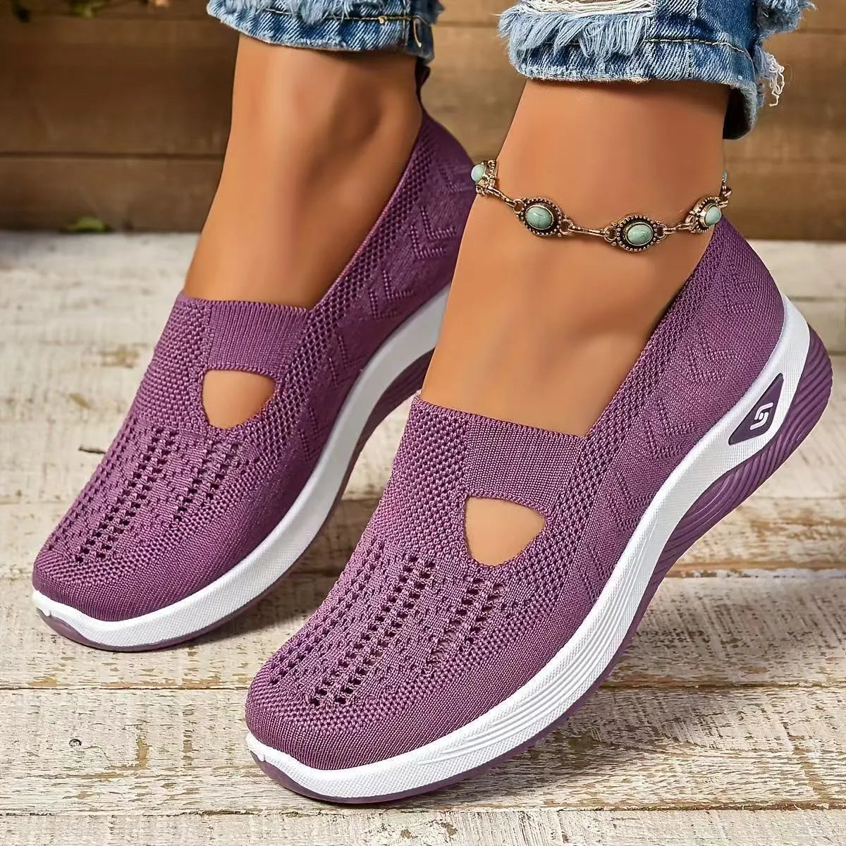 Women's low-top mesh casual flats with a T-strap in various colours on a soft PVC sole.