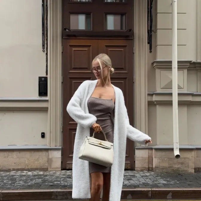 White longline knitted cardigan jacket with long sleeves on a hanger