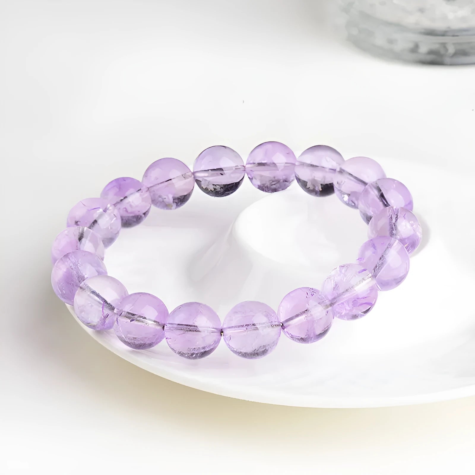 Lavender amethyst round bead bracelet with water ripple pattern on a table.