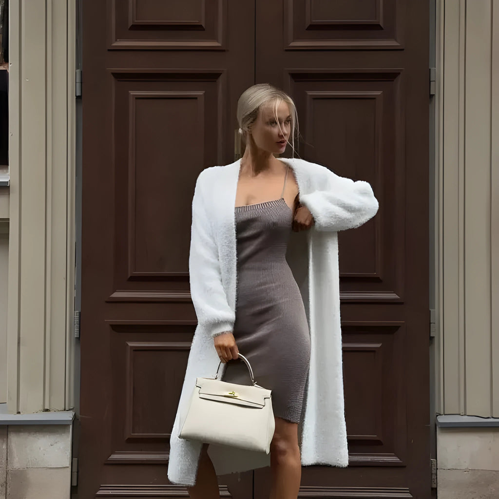 White longline knitted cardigan jacket with long sleeves on a hanger